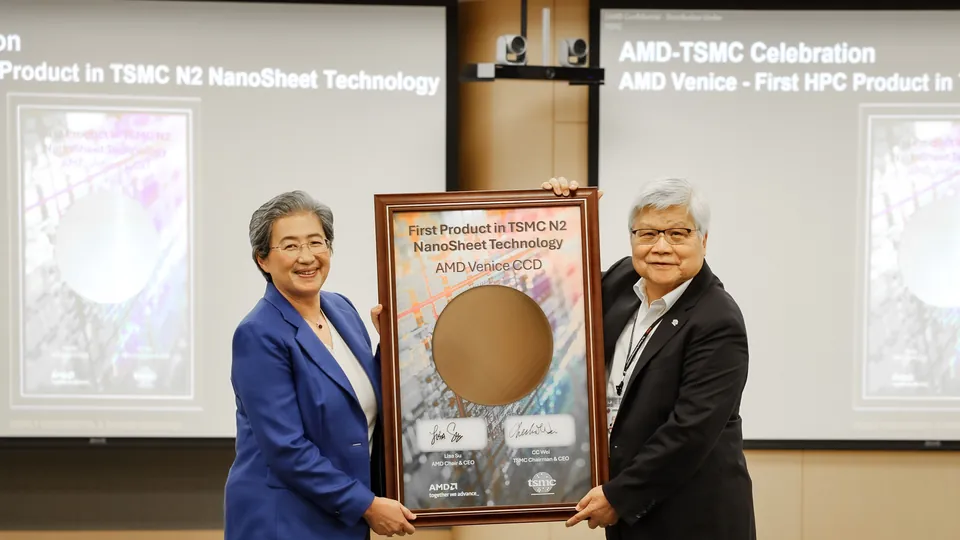 AMD CEO Lisa Su and a TSMC executive holding a framed wafer marking AMD Venice as the first HPC product on TSMC 2nm