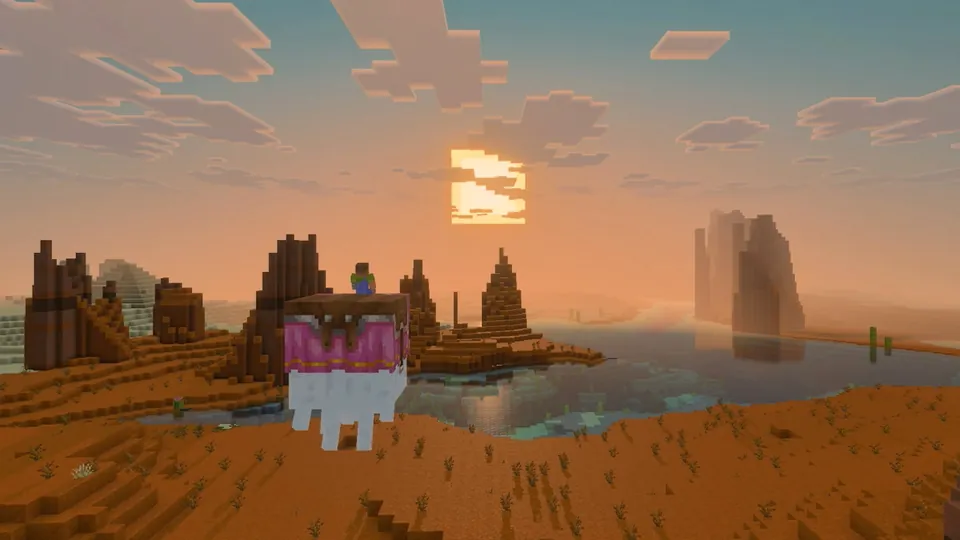 A Minecraft badlands landscape at sunset with long shadows and reflective water, shown with Vibrant Visuals