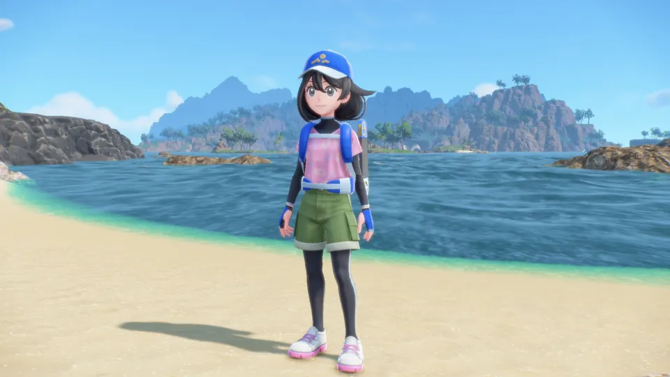 The main character in the Pokémon Waves outfit, with a blue cap, standing on a sandy beach by the sea
