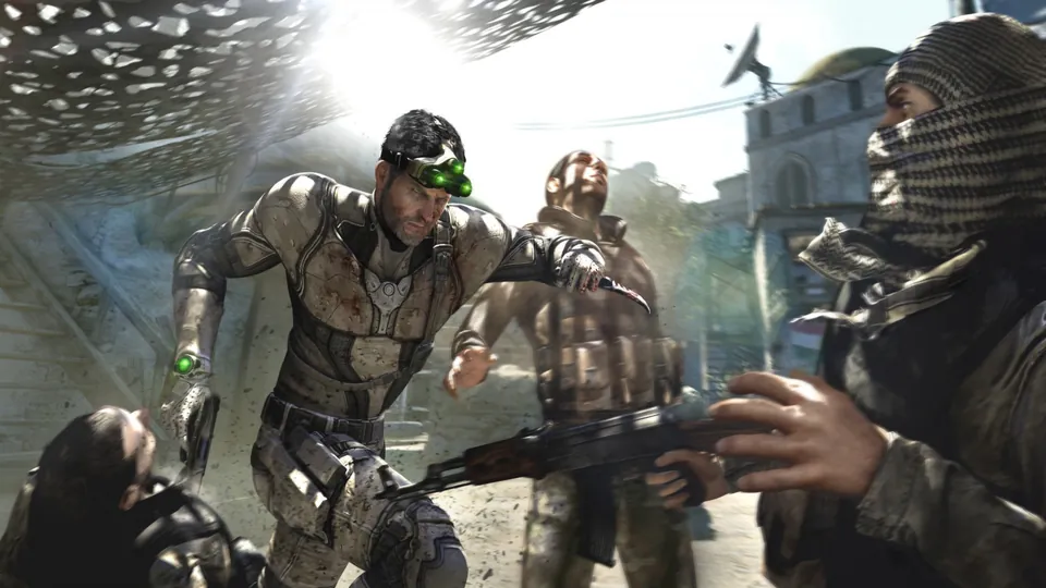 Sam Fisher grabs an armed guard in a bright street in Splinter Cell: Blacklist