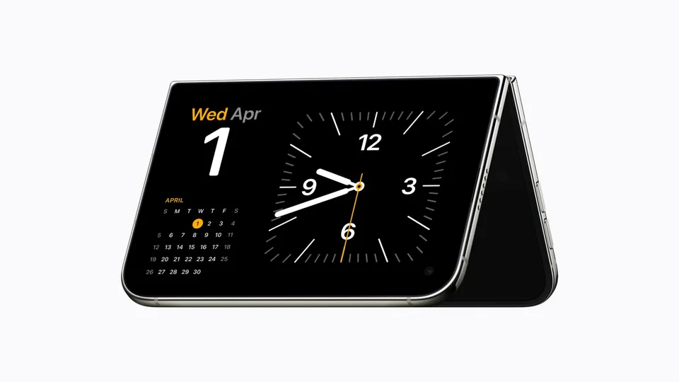 An iPhone Duo folded into a tent shape on a table, showing a clock and calendar in StandBy