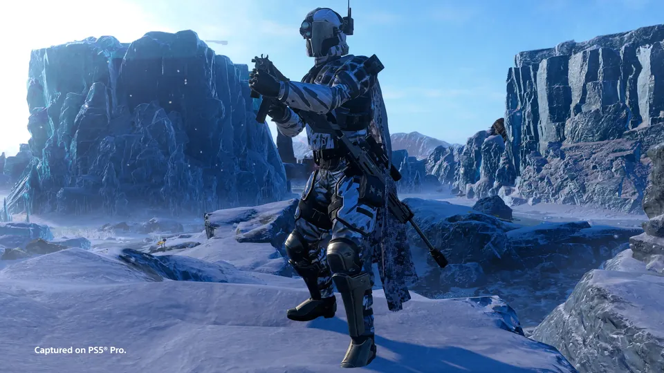 A Helldiver in armor with a dark visor standing among icy cliffs