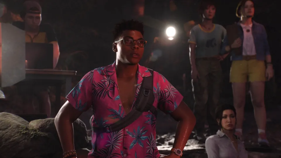 Members of a ghost-hunting crew stand in a dark jungle camp lit by work lights in Until Dawn 2