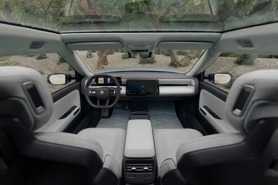 The Rivian R3 interior seen from above, with two front seats, a center screen and a glass roof