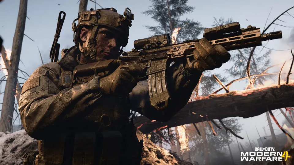 A soldier in a helmet and night-vision mount fires a rifle past a fallen, burning tree in the Modern Warfare 4 campaign
