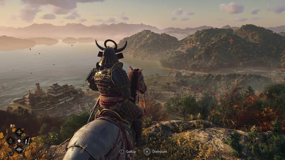 A samurai in a horned helmet sits on horseback on a hill above a coastal castle town in Assassin's Creed Shadows