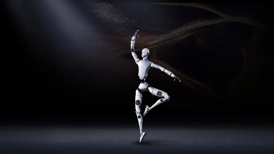 The Unitree H2 humanoid robot balancing on one leg in a ballet pose under a spotlight on a dark stage