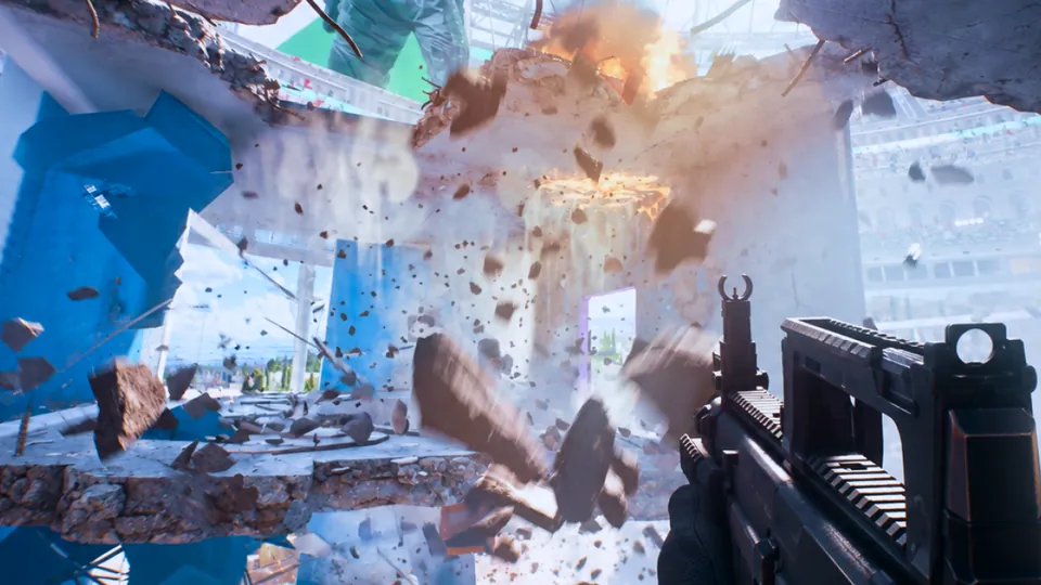 First-person view in THE FINALS with a rifle raised as a concrete floor breaks apart in an explosion inside a stadium Arena