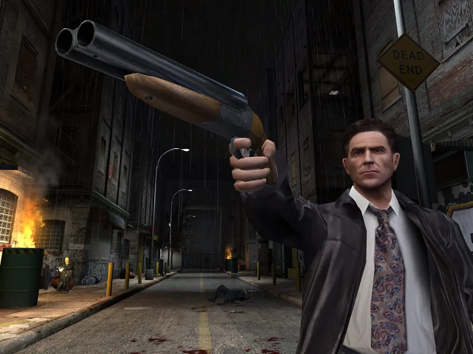 Max Payne aims a pistol in a burning alley at night in Max Payne 2