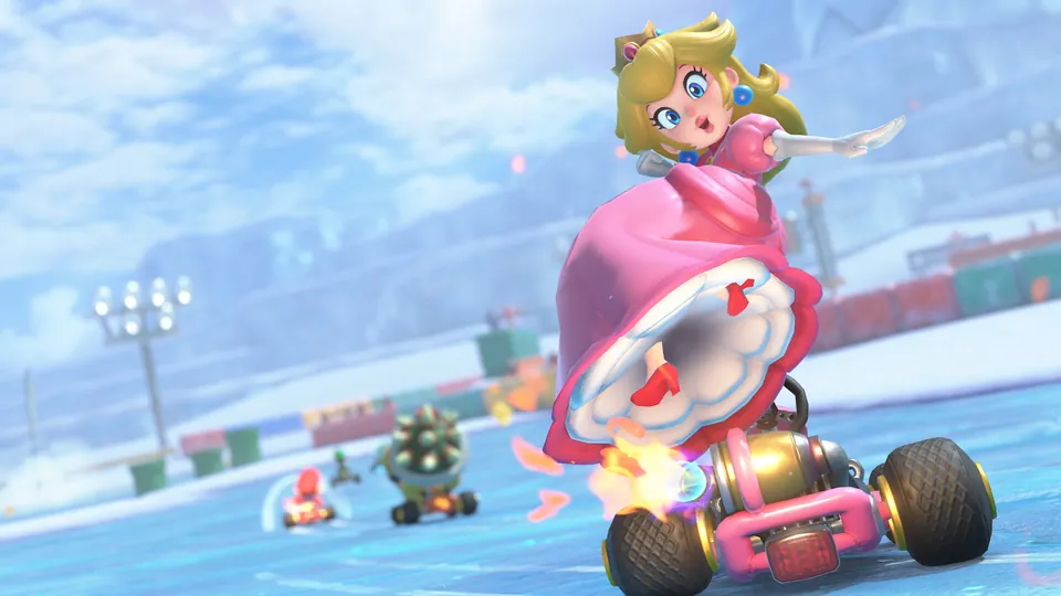 Peach races a pink kart across the icy Vanilla Lake course in Mario Kart World