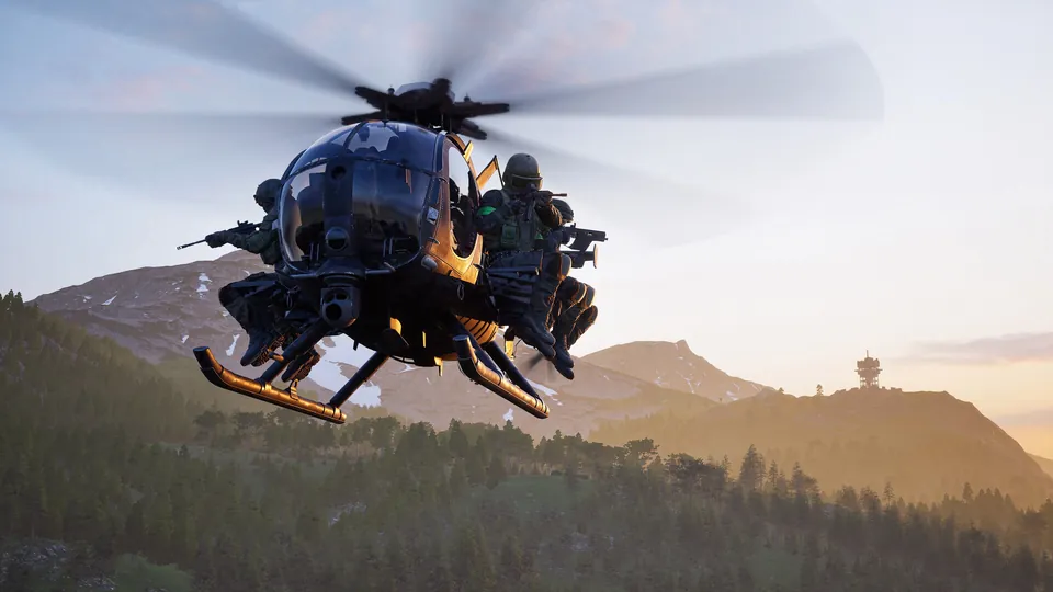 A Wardogs Little Bird helicopter carries soldiers on its side benches over mountains at sunset