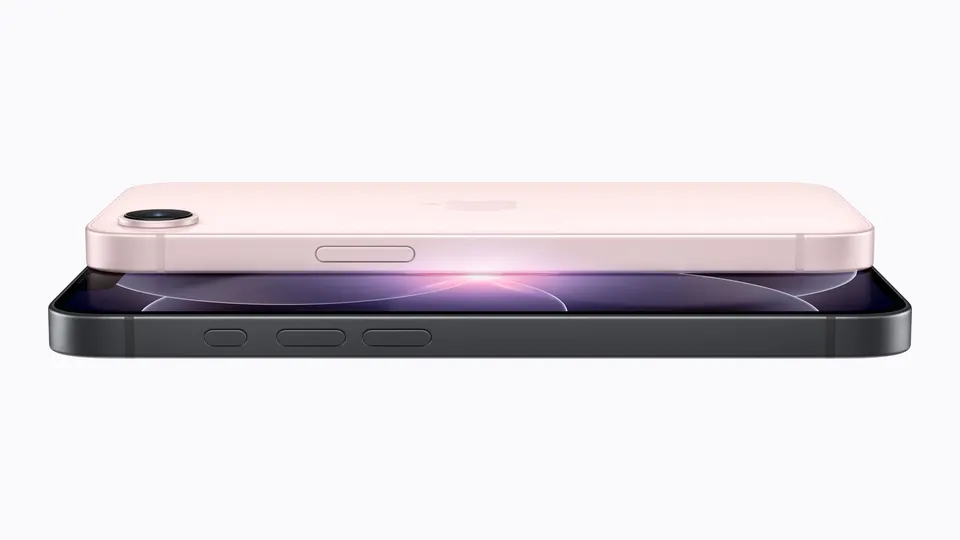 An iPhone 17e in soft pink lying on top of a black iPhone 17e, seen from the side