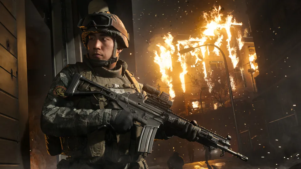 A young South Korean soldier holds a rifle in front of a burning building at night in Call of Duty: Modern Warfare 4