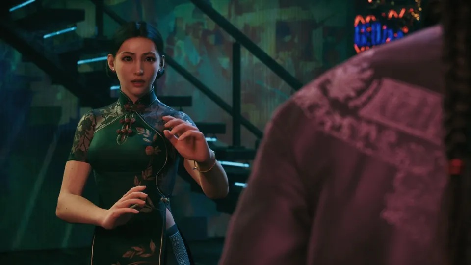 A fighter in a green qipao raises both hands in a ready stance at the foot of a stairway