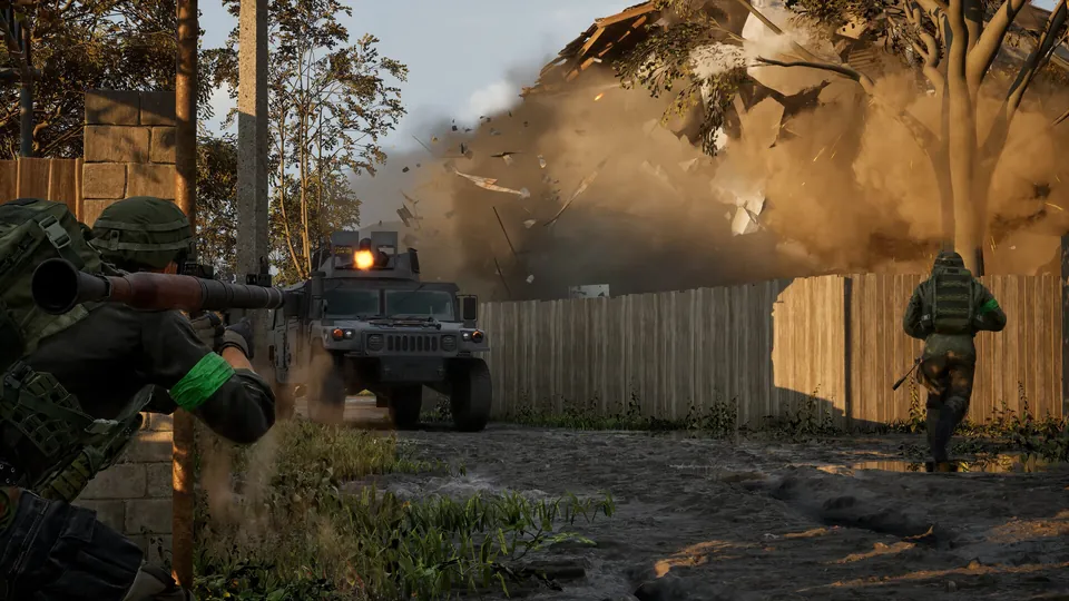 A Wardogs soldier aims a rocket launcher at an armored vehicle as a building explodes