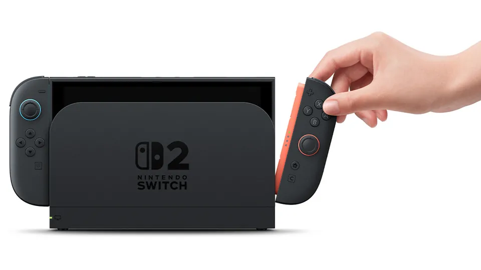 A hand slides the right Joy-Con 2 off a docked Switch 2