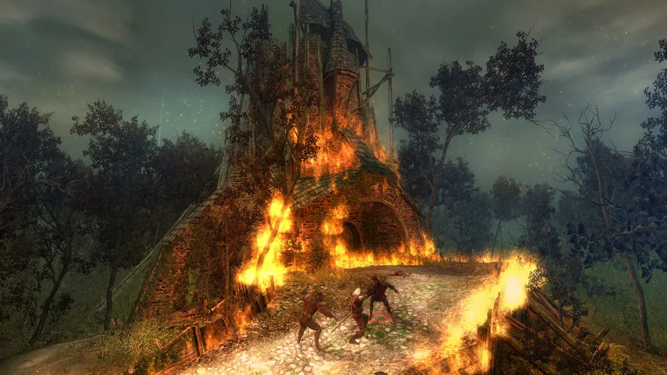 A tall wooden tower burns at night in the original Witcher