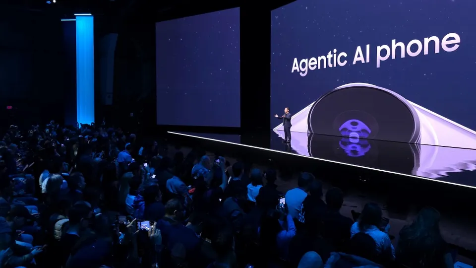 A Galaxy Unpacked 2026 stage screen reading Agentic AI phone above a full audience