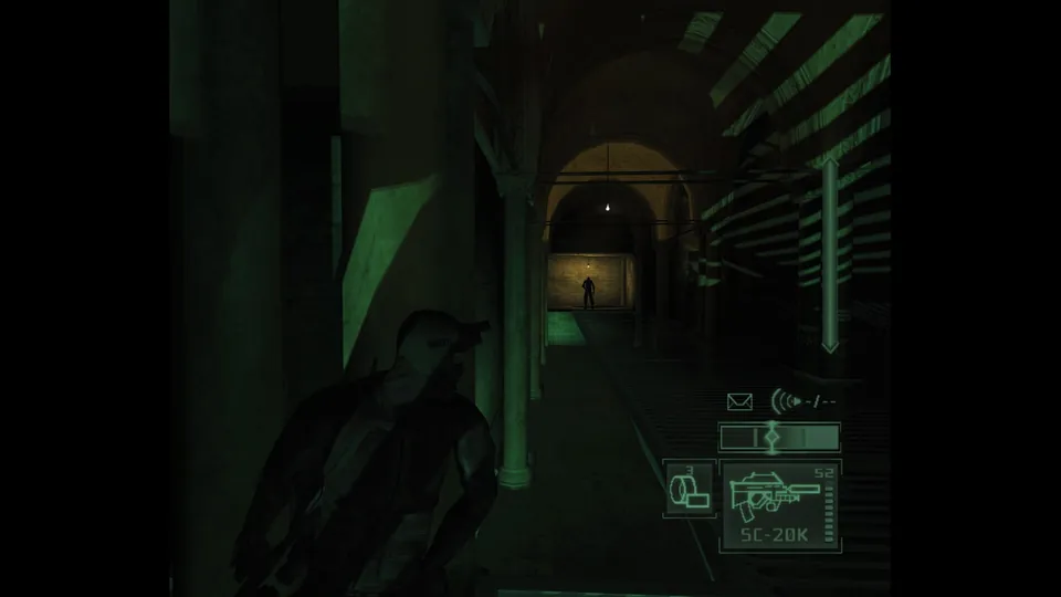 Sam Fisher waits in the shadows of a long arched corridor in Splinter Cell: Pandora Tomorrow