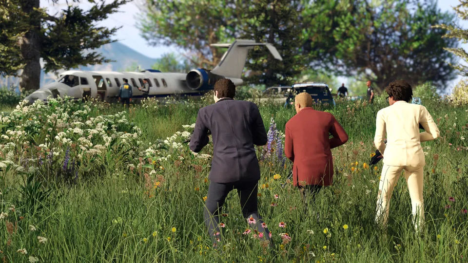 Three characters in suits crouch in tall grass near a crashed jet in Grand Theft Auto V