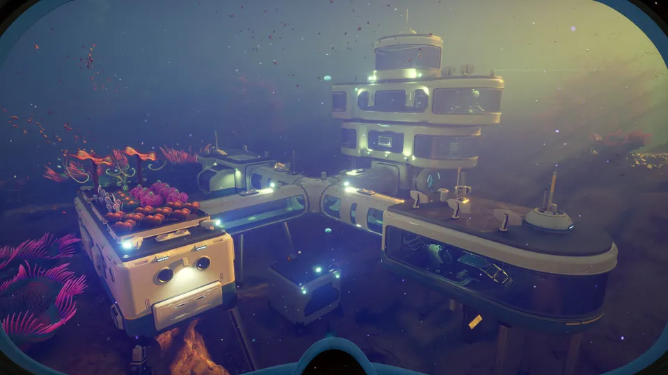 A multi-level underwater base with lit windows sits on the seabed among pink corals in Subnautica 2