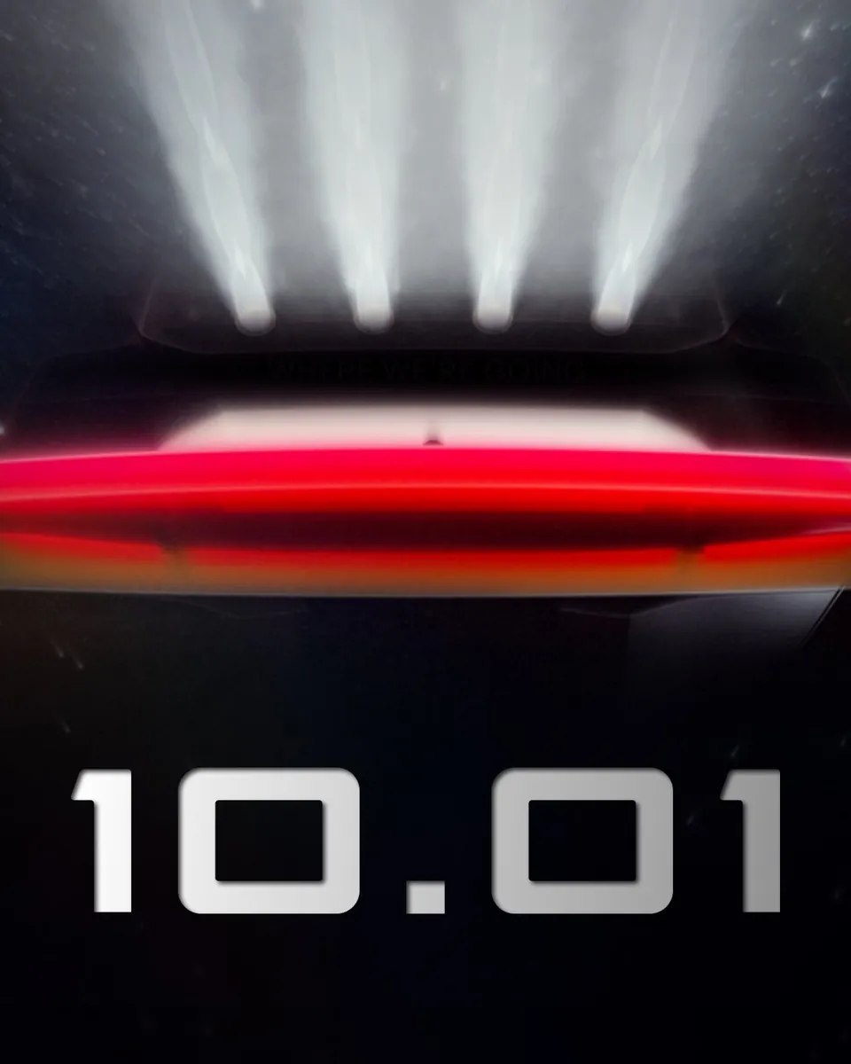 Tesla's first teaser for the Roadster event, showing the back of the car under beams of light and the date 10.01
