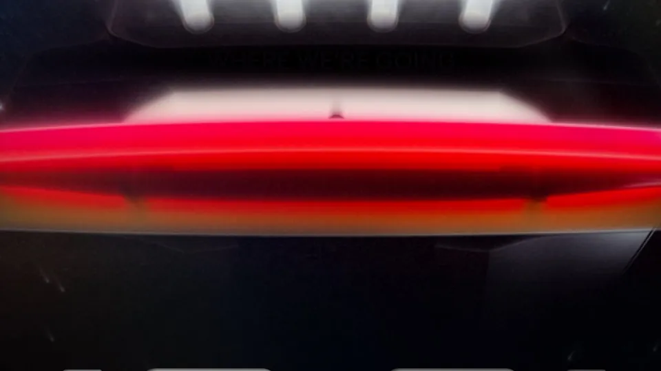 Tesla's first teaser for the Roadster event, showing the back of the car under beams of light and the date 10.01