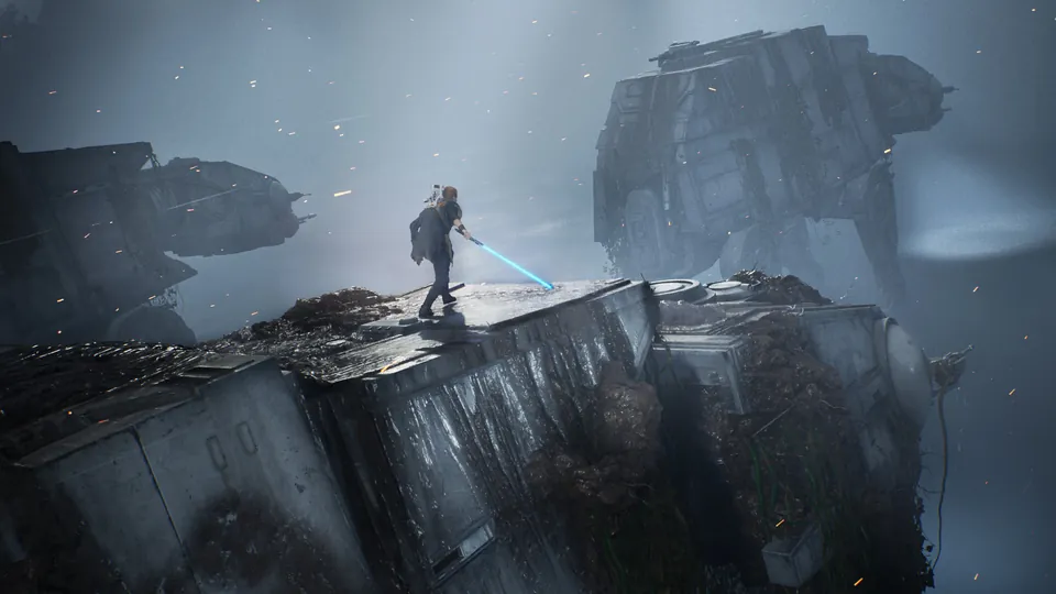 Cal Kestis stands with a lightsaber on top of a wrecked starship hull, with a giant walker wreck in the mist behind, in Star Wars Jedi: Fallen Order
