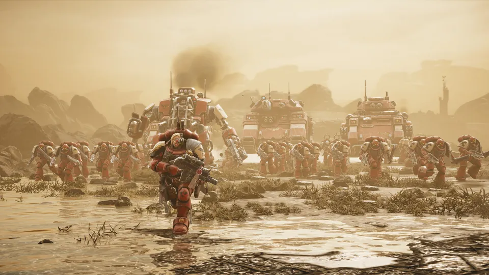 Red Blood Ravens Space Marines charge across a dusty plain with a walker and two tanks behind them in Dawn of War IV
