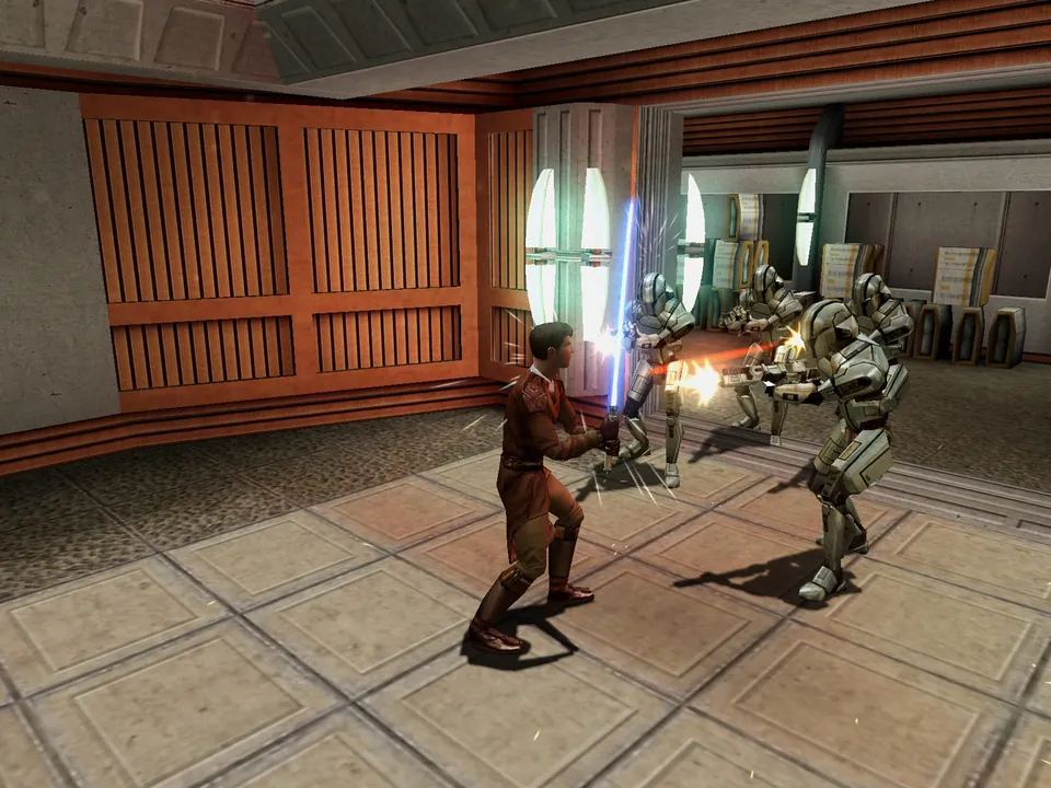 A Jedi with a blue lightsaber fights two droids in the original Star Wars: Knights of the Old Republic