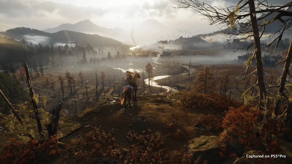 A rider on horseback looks out over a misty valley with a winding river in Ghost of Yōtei
