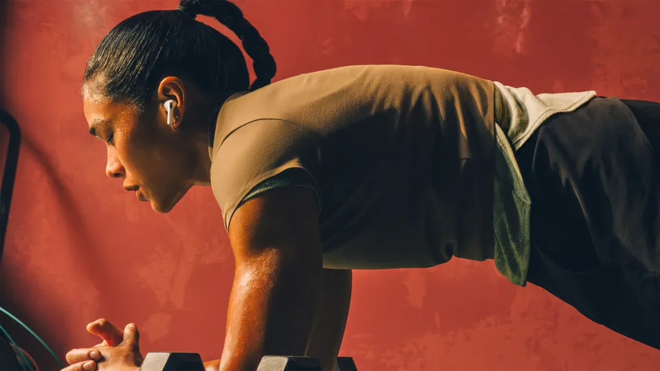 A woman wearing AirPods Pro 3 during a workout