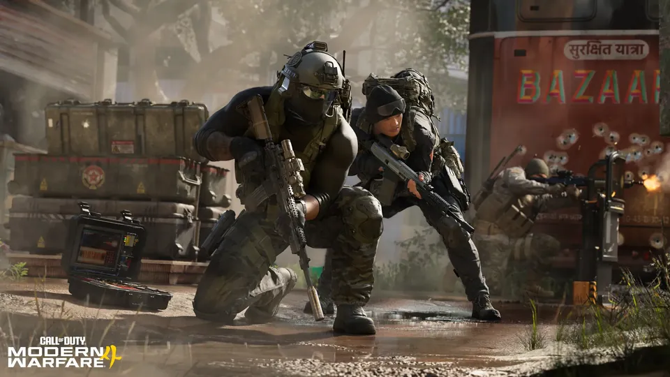 Two operators crouch with rifles beside supply crates on a muddy street in Modern Warfare 4