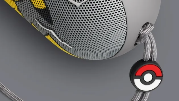 Gray carry lanyard of the Pokémon Beats Pill with a Poké Ball charm