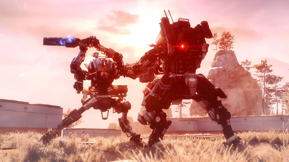 Two titans fight in a grassy field at sunset in Titanfall 2