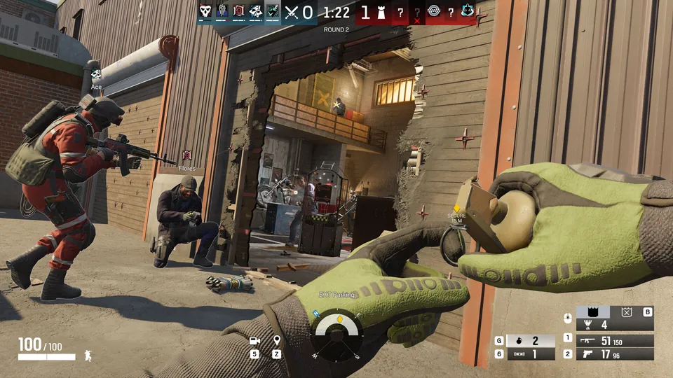 Rainbow Six Siege operators in red gear push through a breached wall in an alley, with a grenade in hand