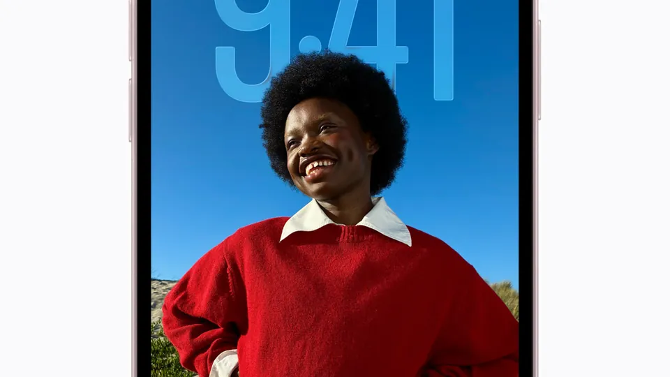 The iPhone 17e lock screen showing the time 9:41 over a photo of a smiling person in a red sweater