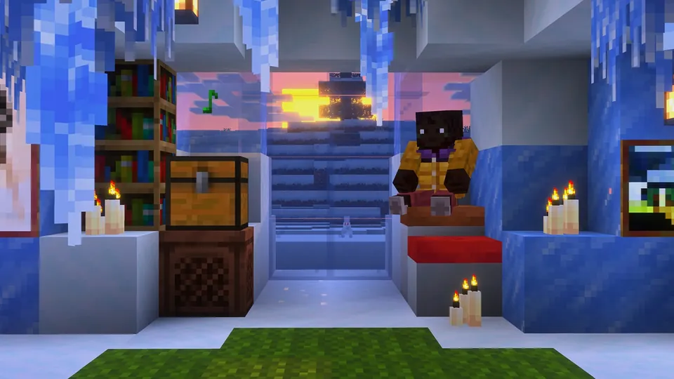 A player sits in an ice-walled room with candles, icicles and a chest on a jukebox, with a sunset outside, in Minecraft