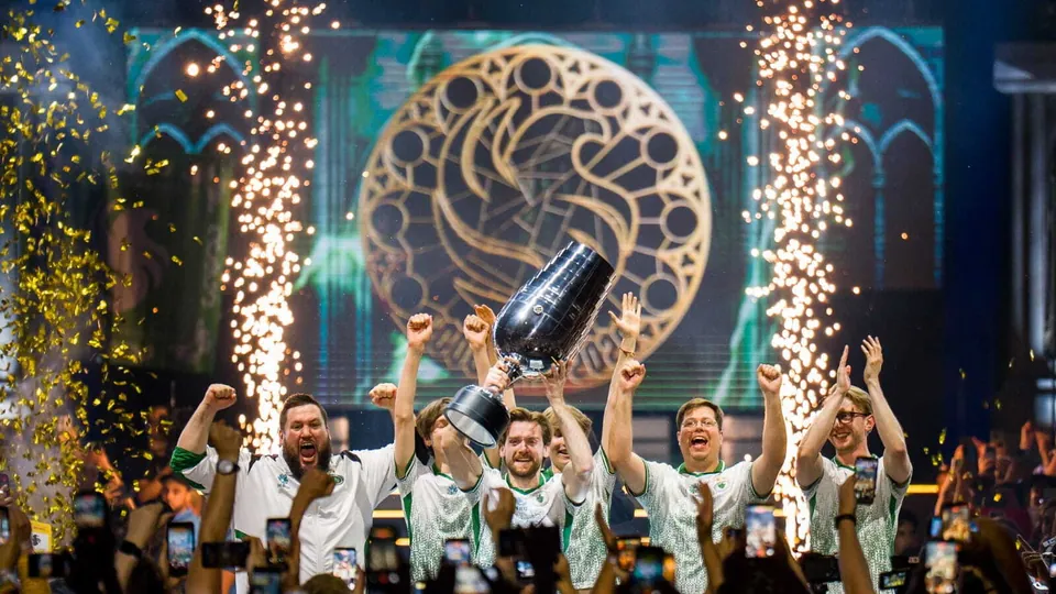 Team Falcons players lift the Major trophy on stage at IEM Cologne 2026 as sparks and confetti fly