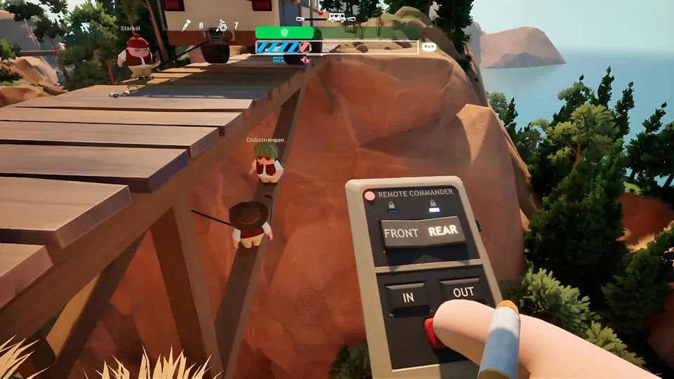 A player holds the Remote Commander winch remote as two friends climb a beam under a wooden bridge on a seaside cliff in RV There Yet?