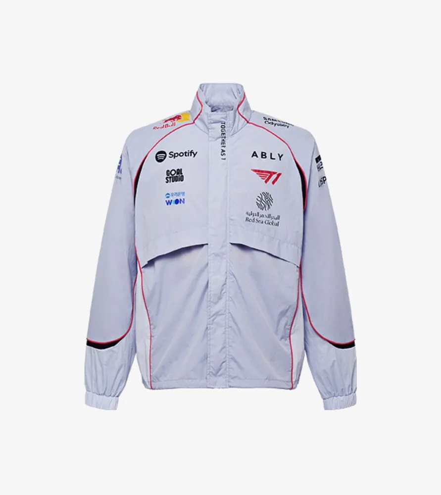 The front of T1's light gray 2026 International Jacket with a stand collar, red trim and sponsor logos