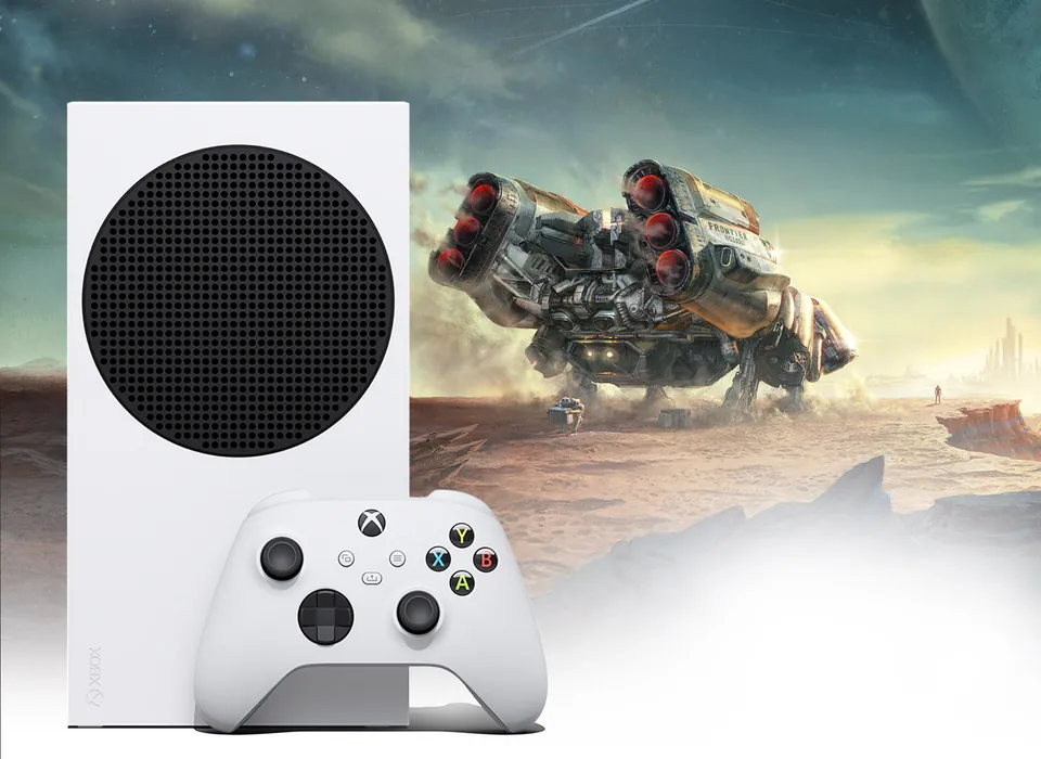 A white Xbox Series S standing next to a white controller in front of a spaceship on a desert planet