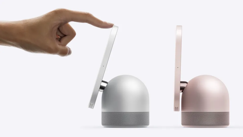 A finger tilting the HomeView screen on its hinge, next to a rose pink HomeView
