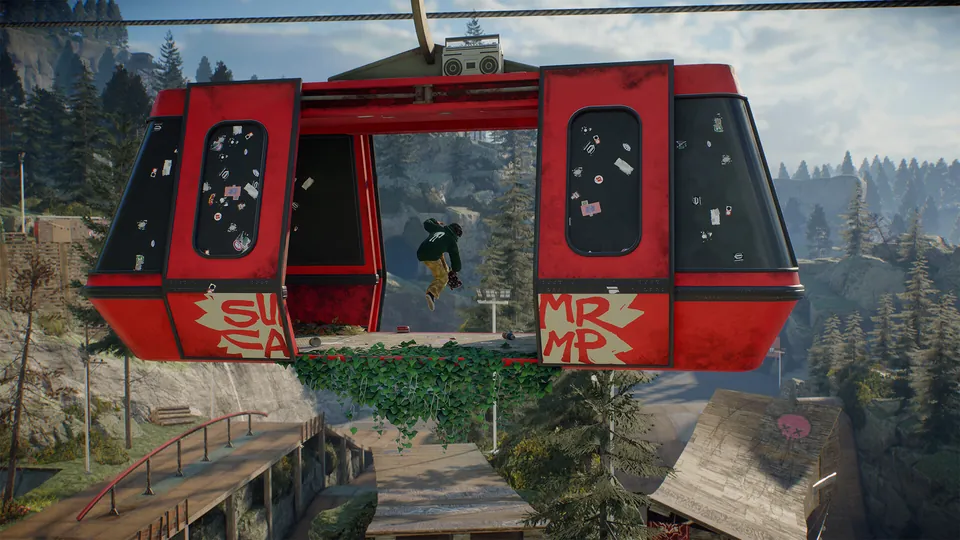 A red gondola cabin covered in stickers hangs over a mountain skate park as a skater rides below in skate.