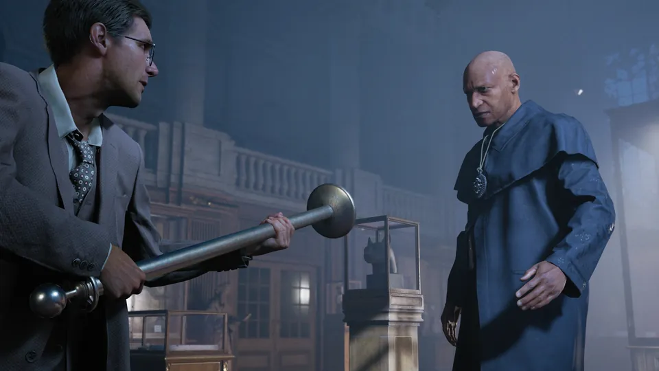 A man in a suit holds a metal rod as a tall man in a blue robe stands by a lit window at night
