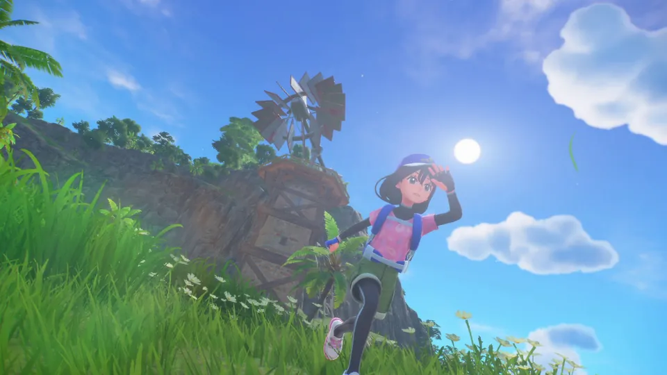 A trainer shades their eyes on a grassy island hill with a windmill behind