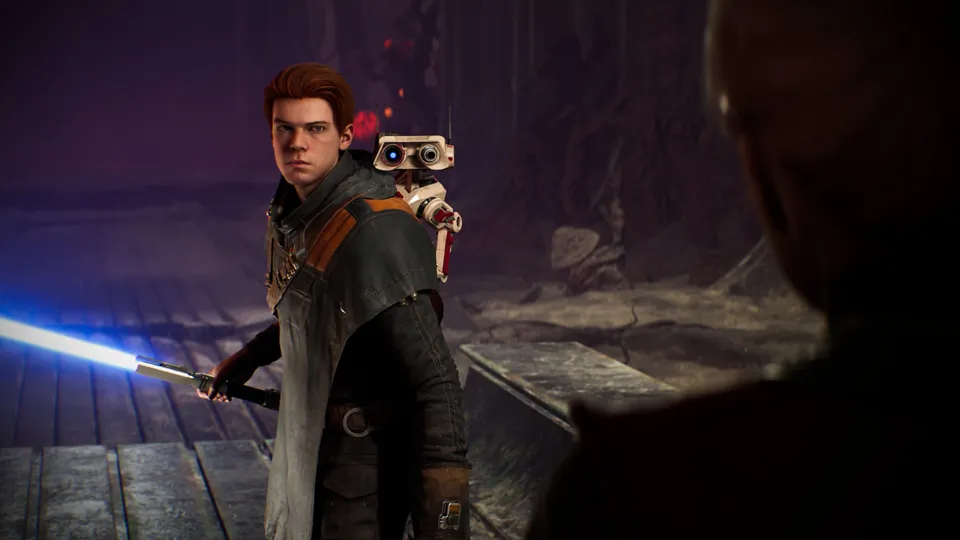 Cal Kestis holds a blue lightsaber with the droid BD-1 on one shoulder in a dark wooden hall in Star Wars Jedi: Fallen Order