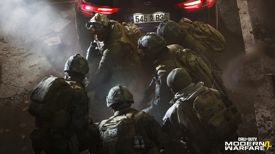 A squad of soldiers crouches behind a car in a smoky street in Call of Duty: Modern Warfare 4