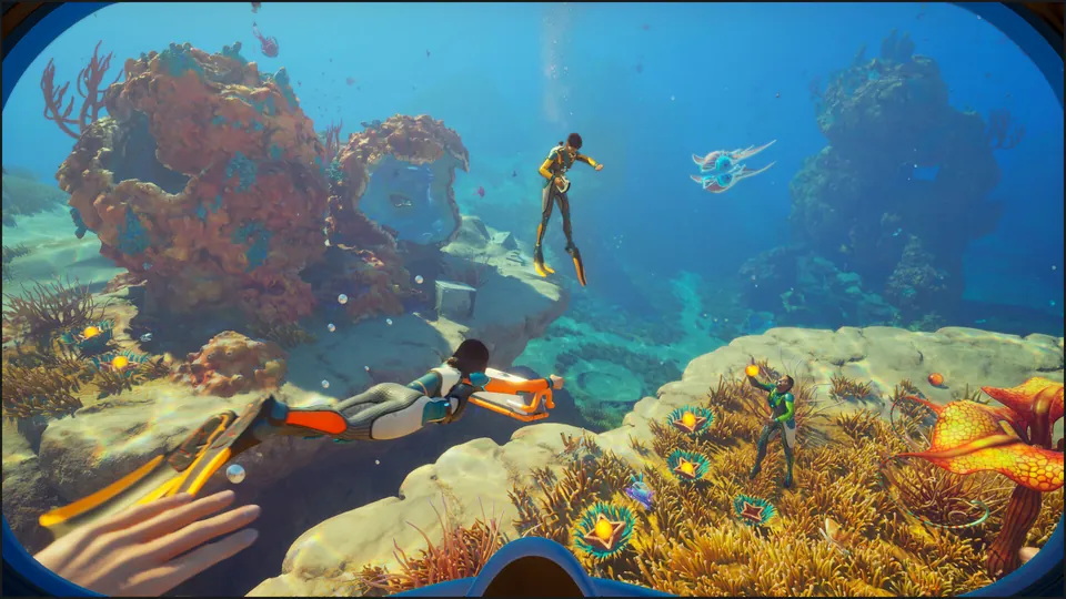 Three divers swim over a bright coral reef with orange plants and a floating creature in Subnautica 2