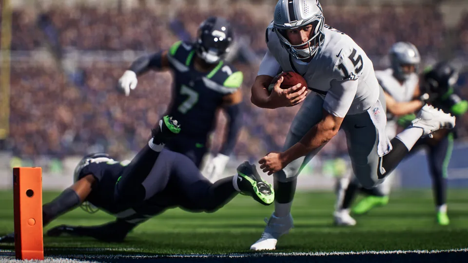 A Raiders quarterback dives for the pylon past Seahawks defenders in Madden NFL 27